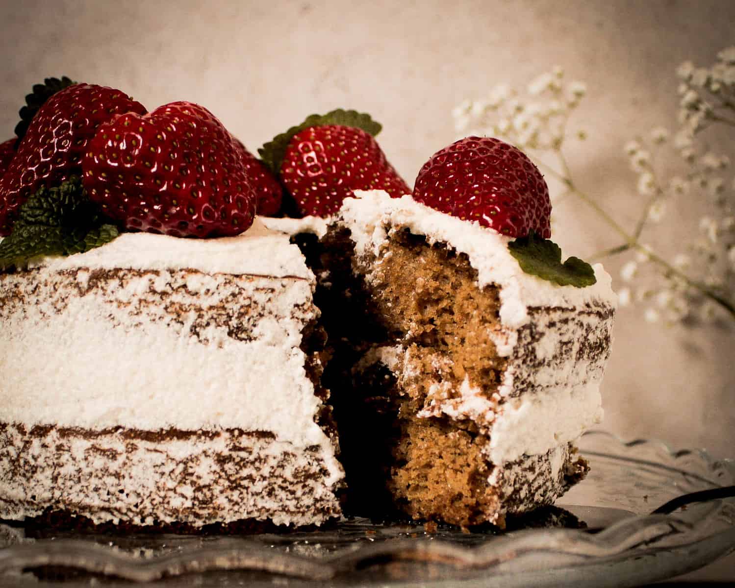 vegan naked cake with strawberries and lemon balm