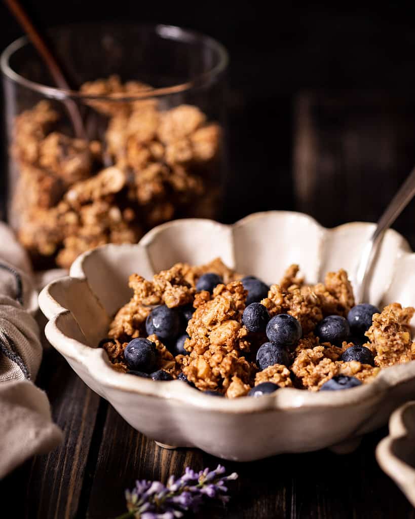 Almond Buckwheat granola clusters in a bowl with blueberries