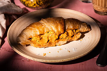 vegan croissant with tofu scramble and peanut sauce