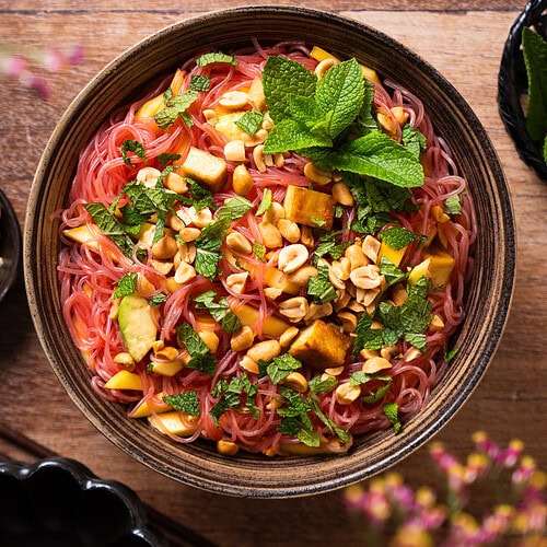 Vietnamese-Inspired Vegan Glass Noodle Salad with Mango and Avocado in big bowl for buffet